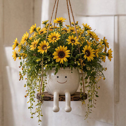 Florawipp – Schwingstuhl-Blumentopf mit Smiley-Detail