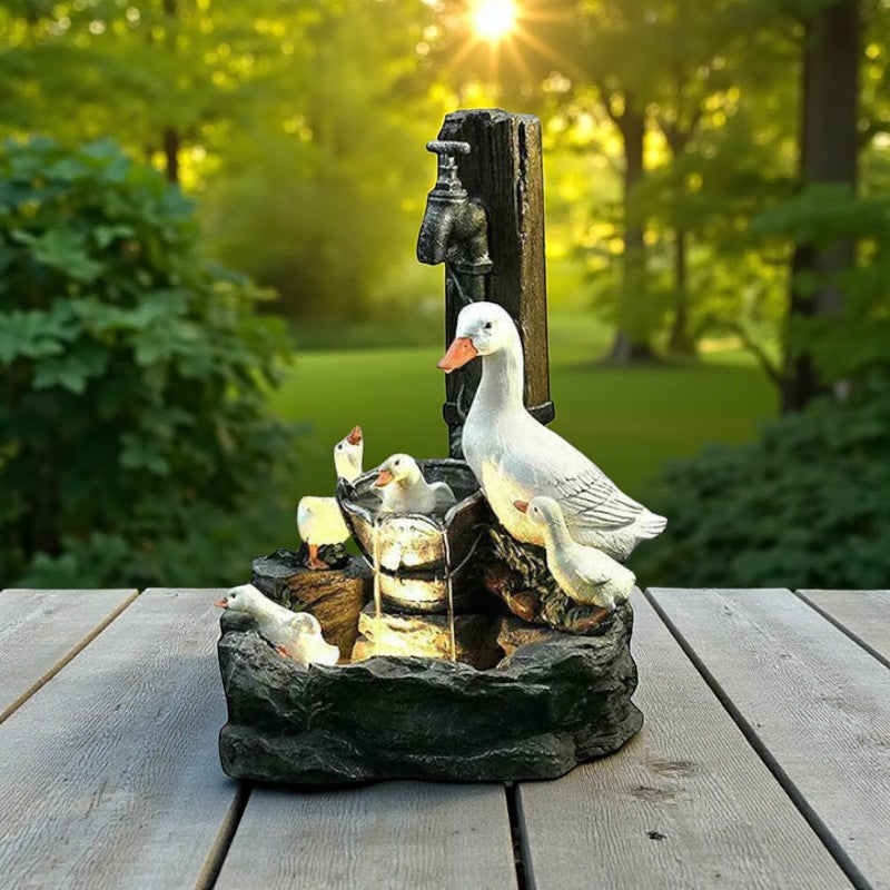 Wasserbrunnen mit plätschernder Entenfamilie