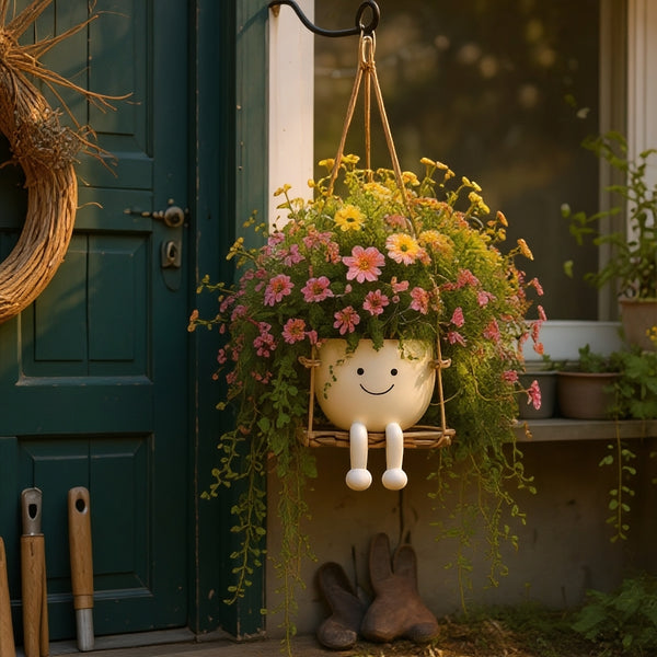 Florawipp – Schwingstuhl-Blumentopf mit Smiley-Detail
